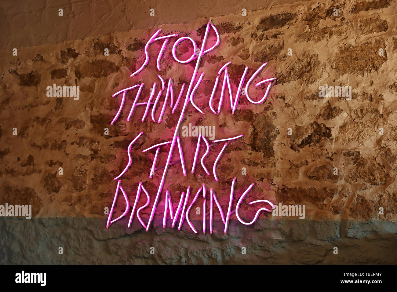 Neon sign on stone wall Stock Photo Alamy