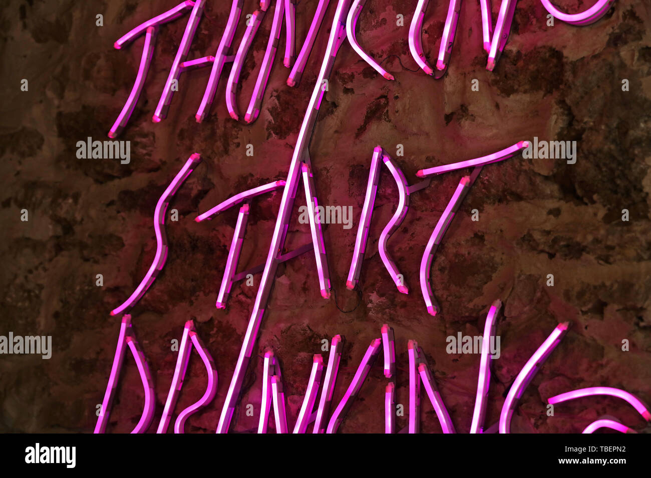 Neon sign on stone wall Stock Photo Alamy