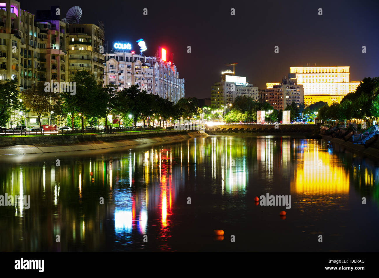 Bucharest, Romania - May 09, 2019: Palace of Parliament reflected in Dambovita river, at night, with calm waters. Night scene in downtown Bucharest, R Stock Photo