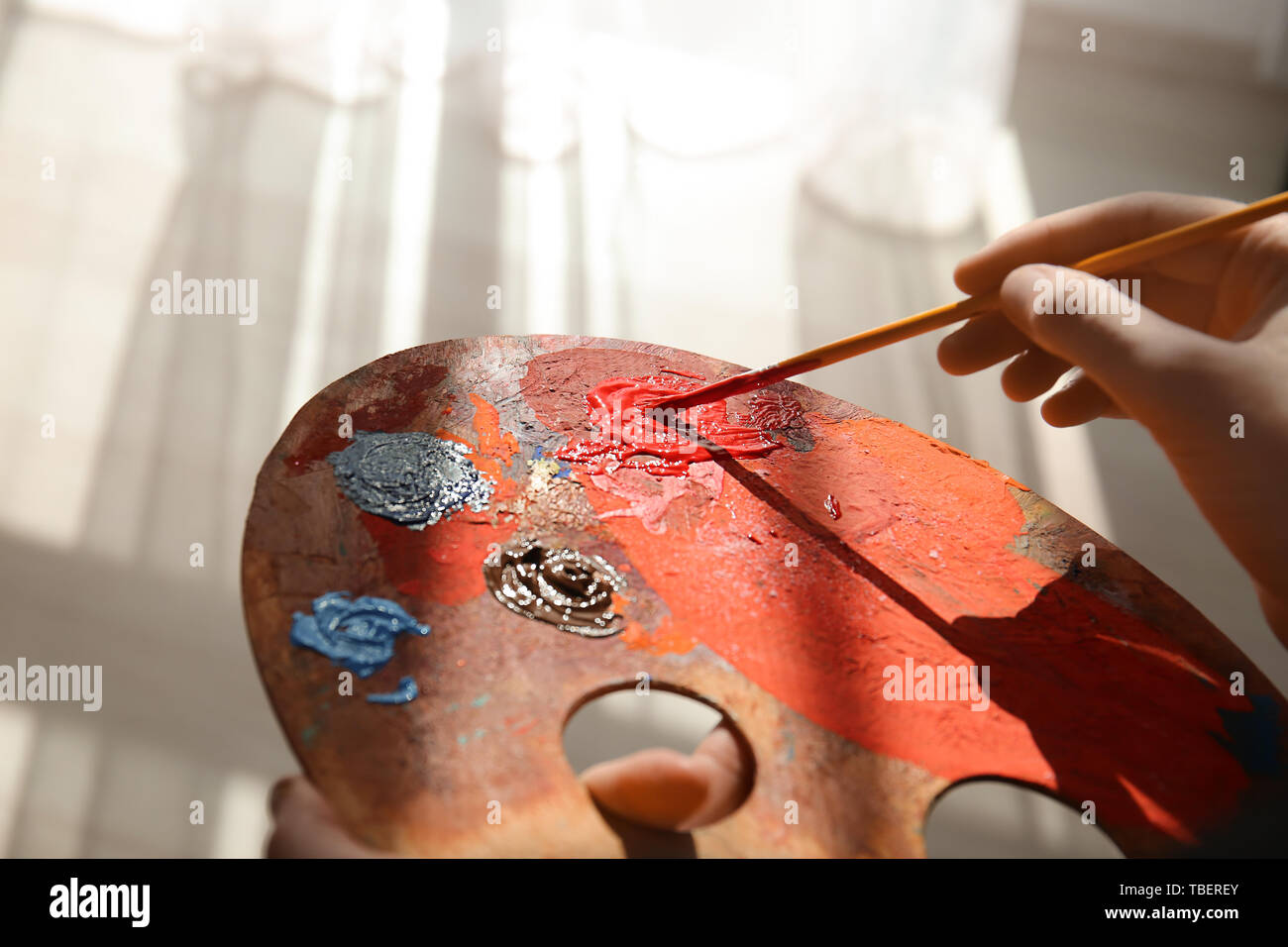 Female artist with paint palette and brush in studio, closeup Stock ...