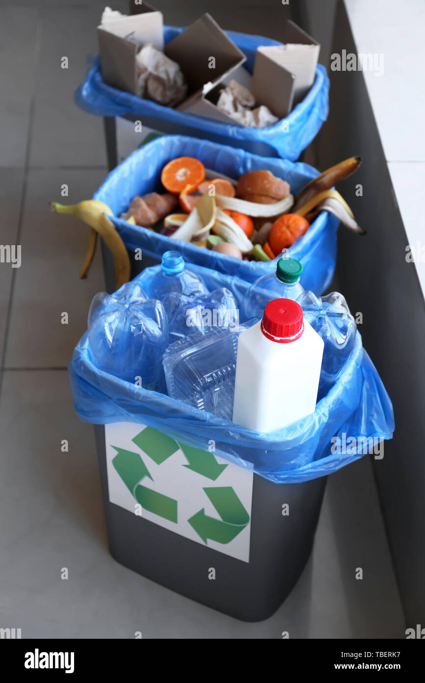 Trash bins with different types of garbage indoors Stock Photo Alamy