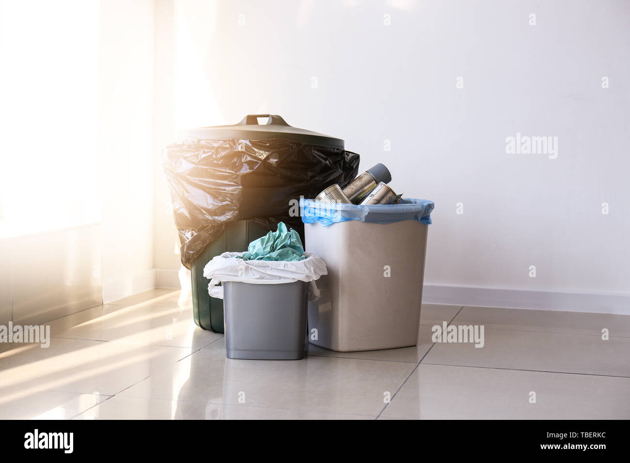 Trash bins with different types of garbage indoors Stock Photo Alamy