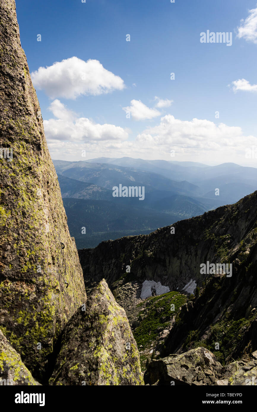 Rocks under blue sky with clouds. View of mountain valley. Tourism ...