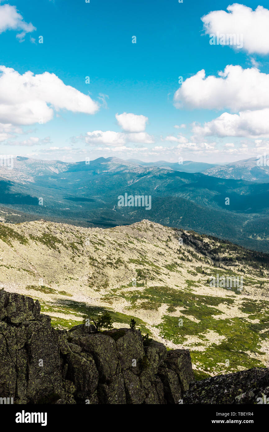 Rocks under blue sky with clouds. View of mountain valley. Tourism ...
