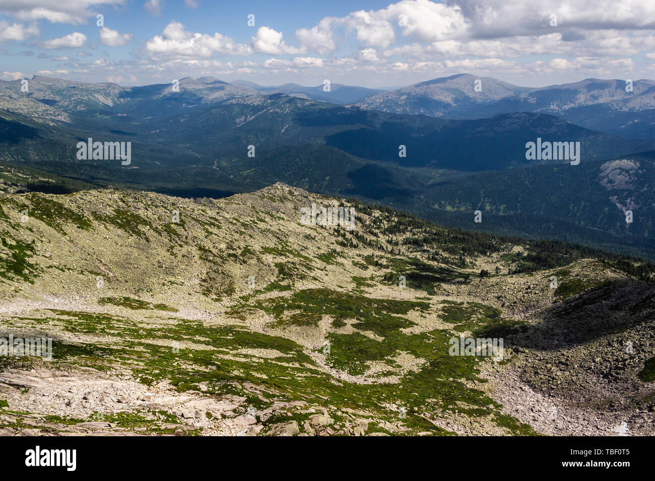 Rocks under blue sky with clouds. View of mountain valley. Tourism ...