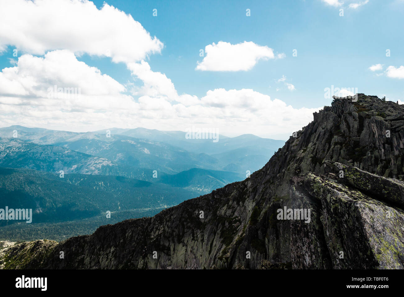 Rocks under blue sky with clouds. View of mountain valley. Tourism ...