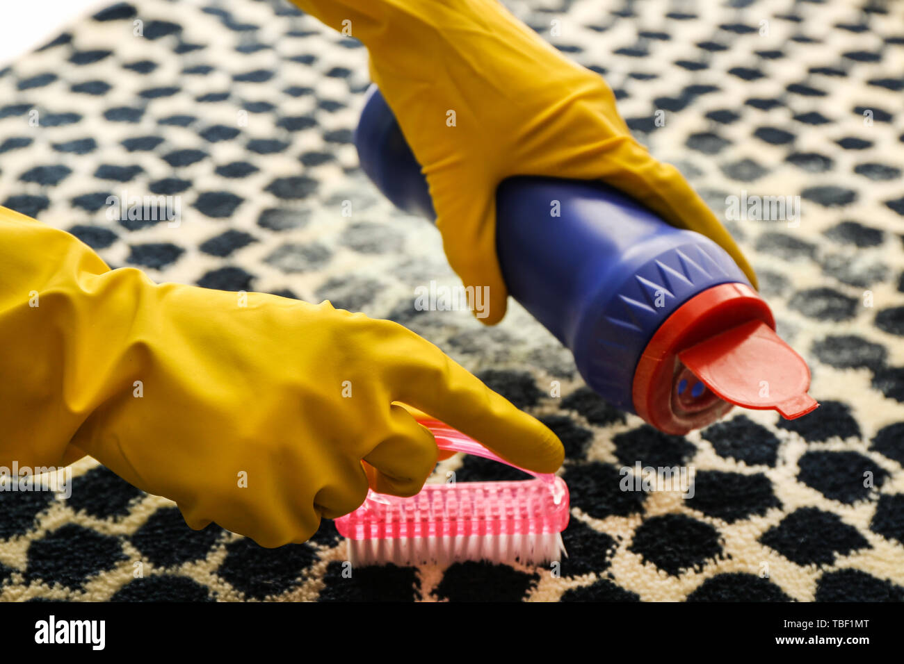 Woman cleaning carpet Stock Photo