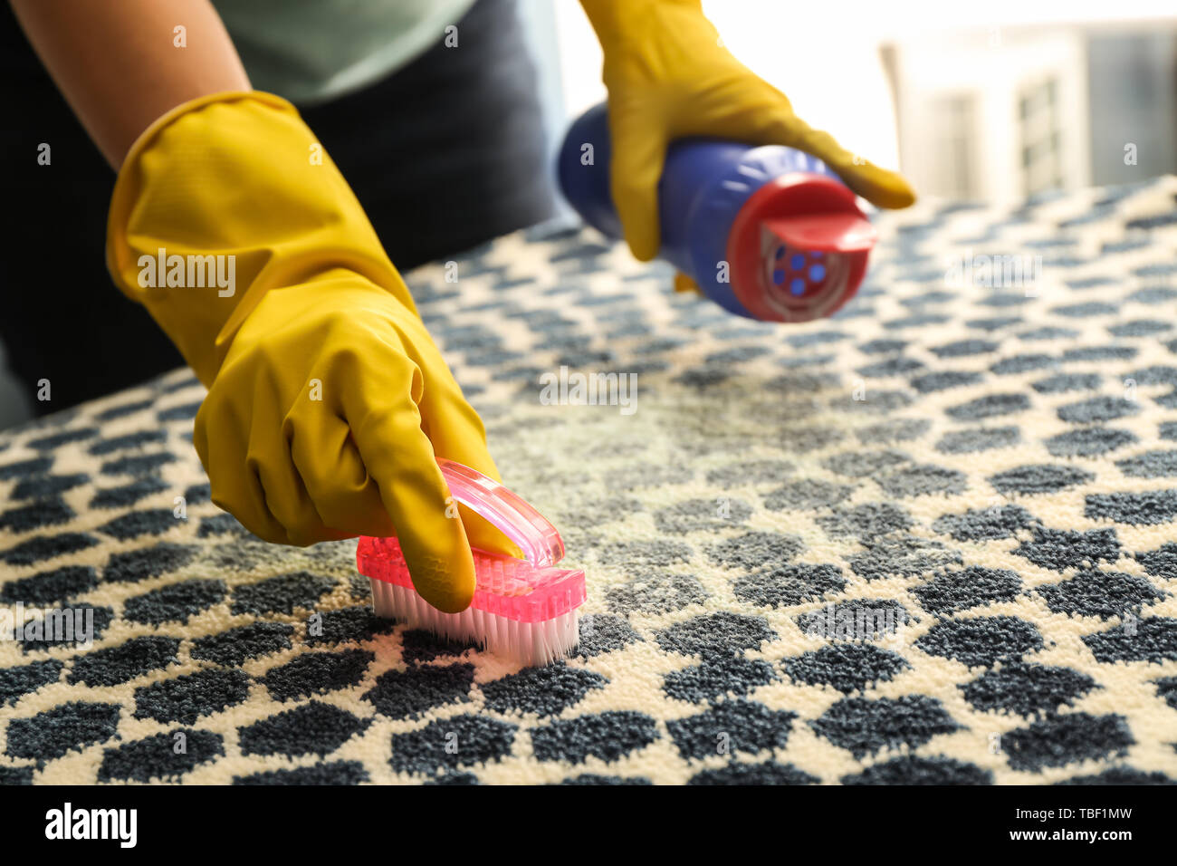 Woman cleaning carpet Stock Photo