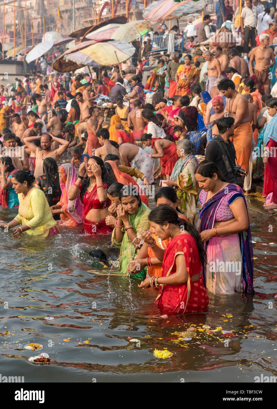 Hindu believers bath and perform ritual bath and puja prayers at ghats