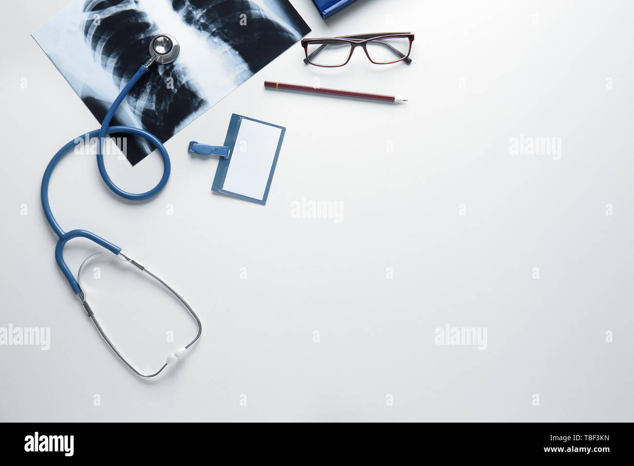 Stethoscope, badge and X-ray image on white background Stock Photo - Alamy