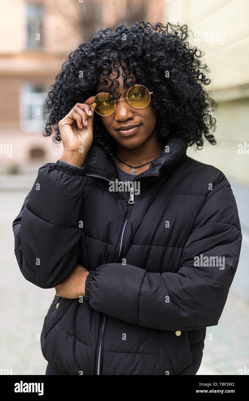 Young Black Woman With Afro Hairstyle Standing In An Urban Street