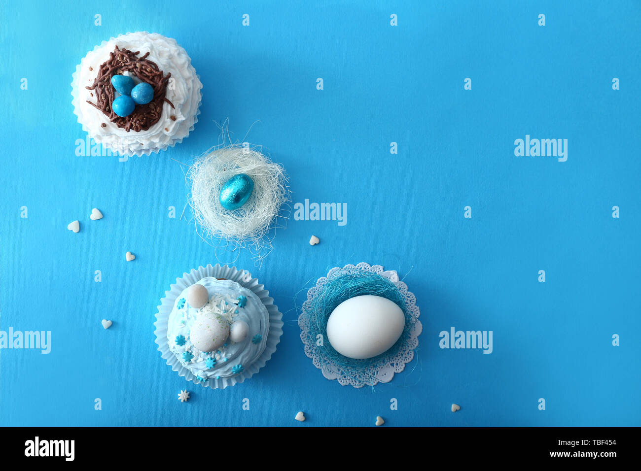 Tasty Easter cupcakes with eggs on color background Stock Photo