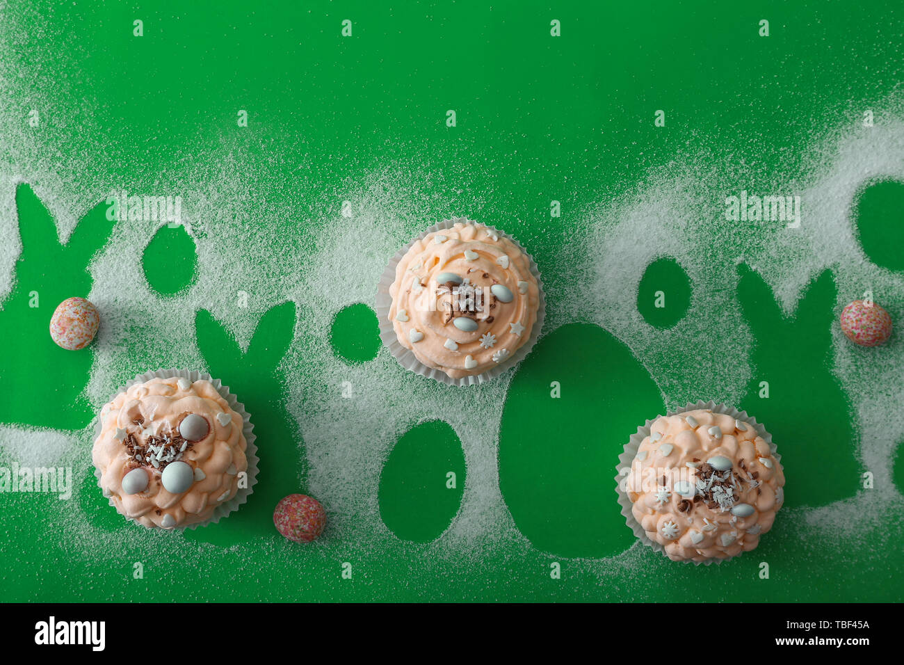 Tasty Easter cupcakes on color background Stock Photo