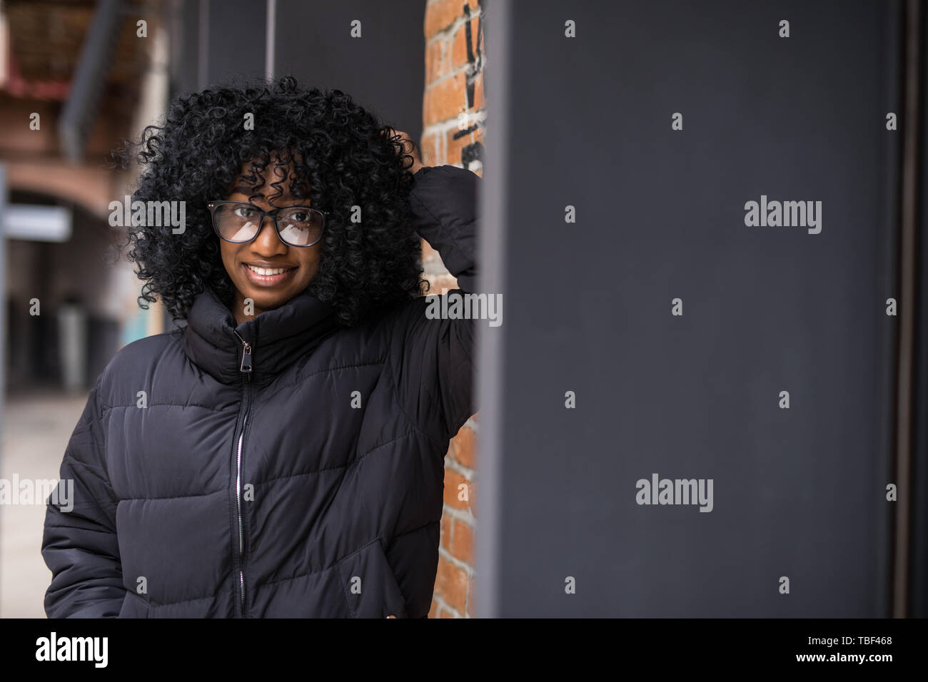 Young cool black skin girl walking in the street. Stock Photo