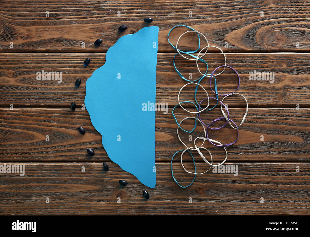 Creative hemispheres of brain on wooden background. Concept of healthy brain Stock Photo