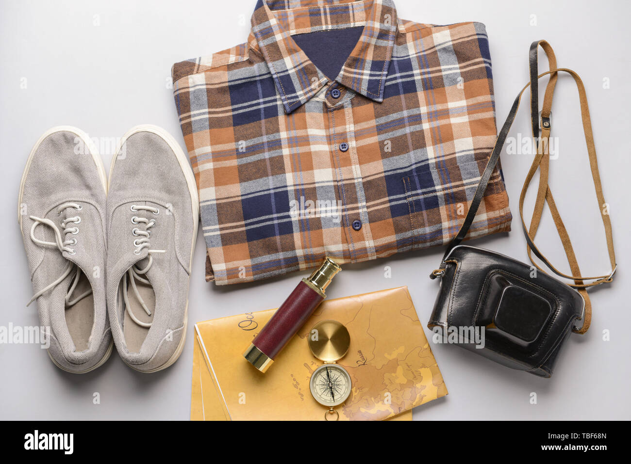 Male clothes with travel objects on light background Stock Photo