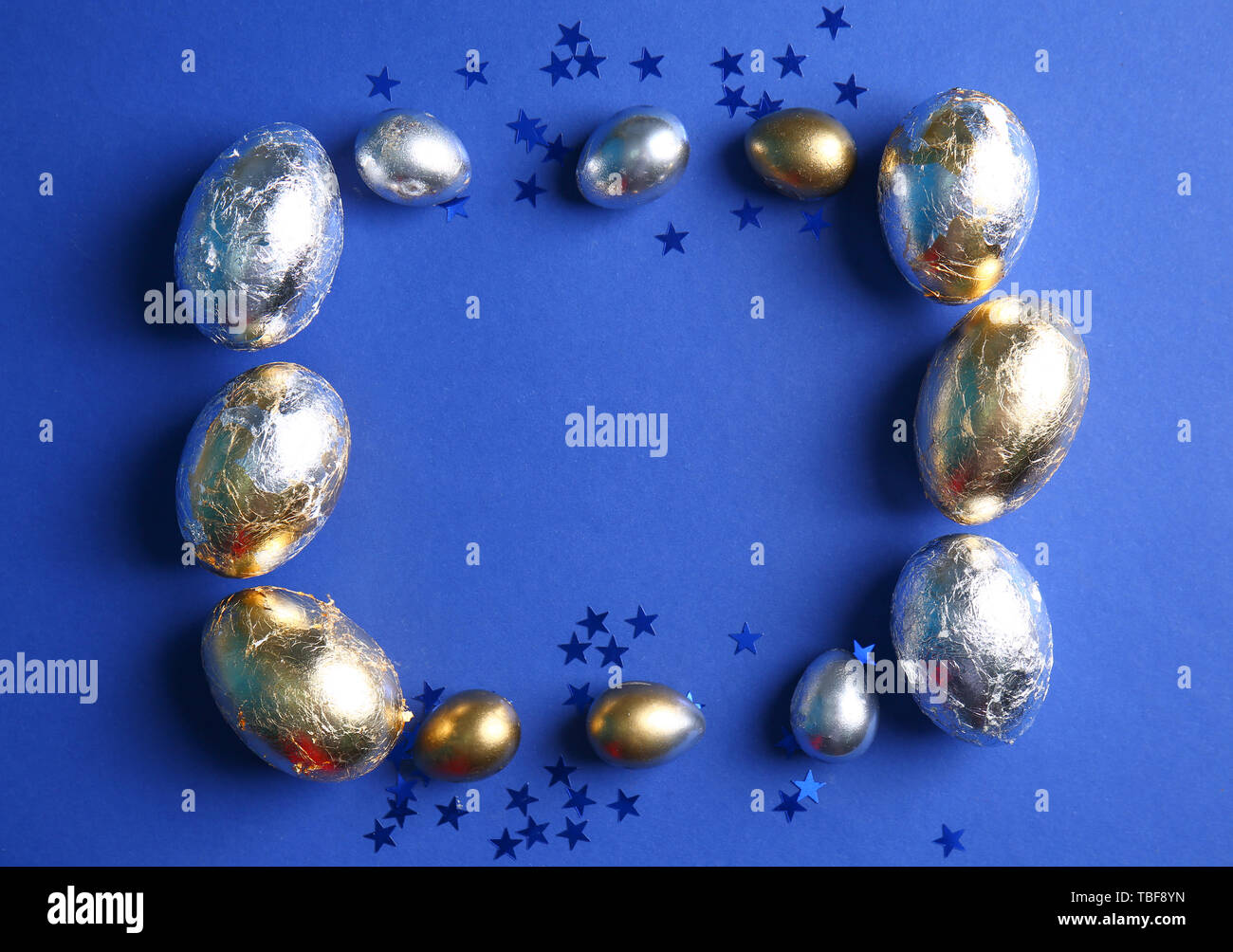 Frame made of Easter eggs on color background Stock Photo