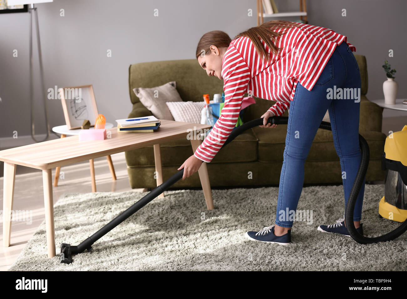 Beautiful woman with vacuum cleaner at home Stock Photo - Alamy