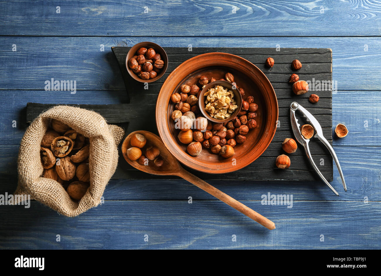 Different tasty nuts on wooden table Stock Photo