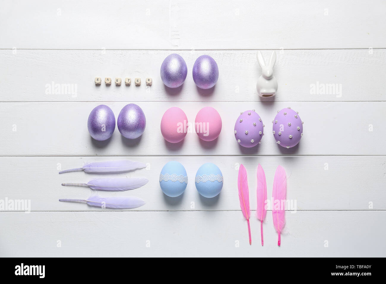 Easter composition with painted eggs on white wooden background Stock Photo