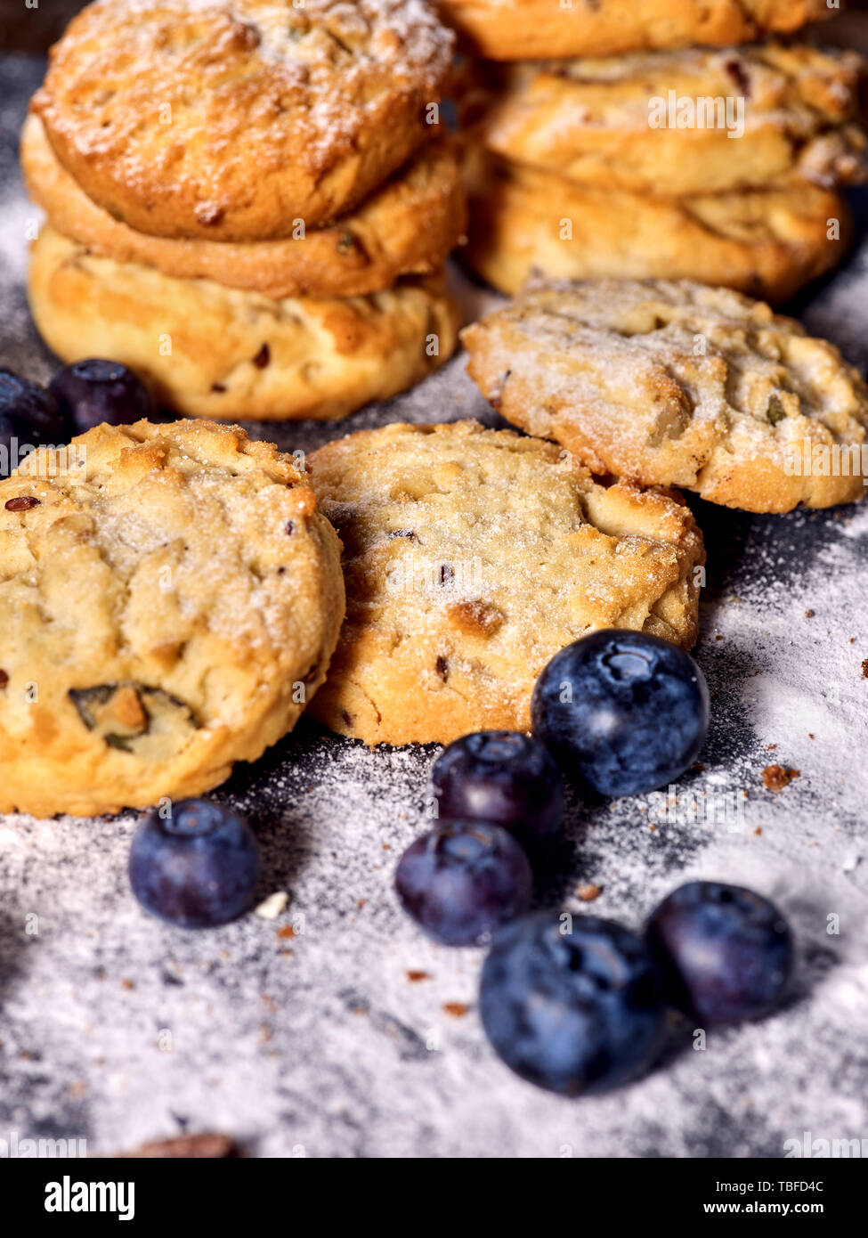 Bakers gonna bake. Serving food on slate. Oatmeal cookies biscuit with blueberry on dark tiles countrylike. Chocolate chip cookies shop on window disp Stock Photo