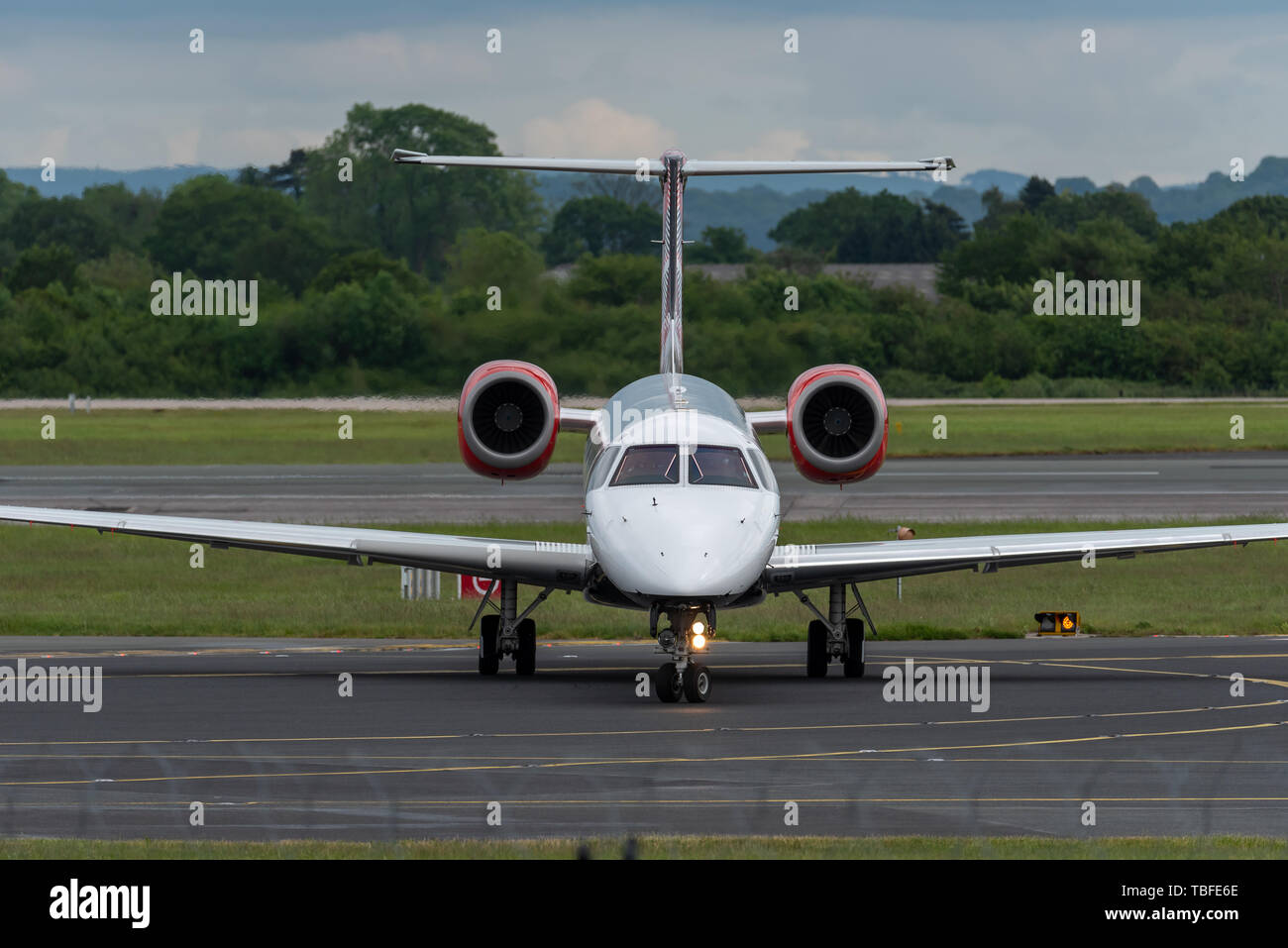 MANCHESTER UK, 30 MAY 2019: Loganair Embraer ERJ-145EP flight LM595 from Inverness turns off Runway 28R at Manchester Airport after landing. Stock Photo