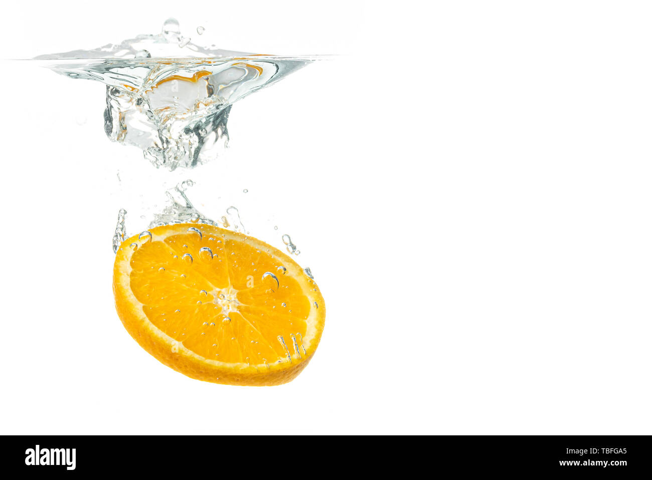 Orange fruit slice in water splash on white background Stock Photo - Alamy