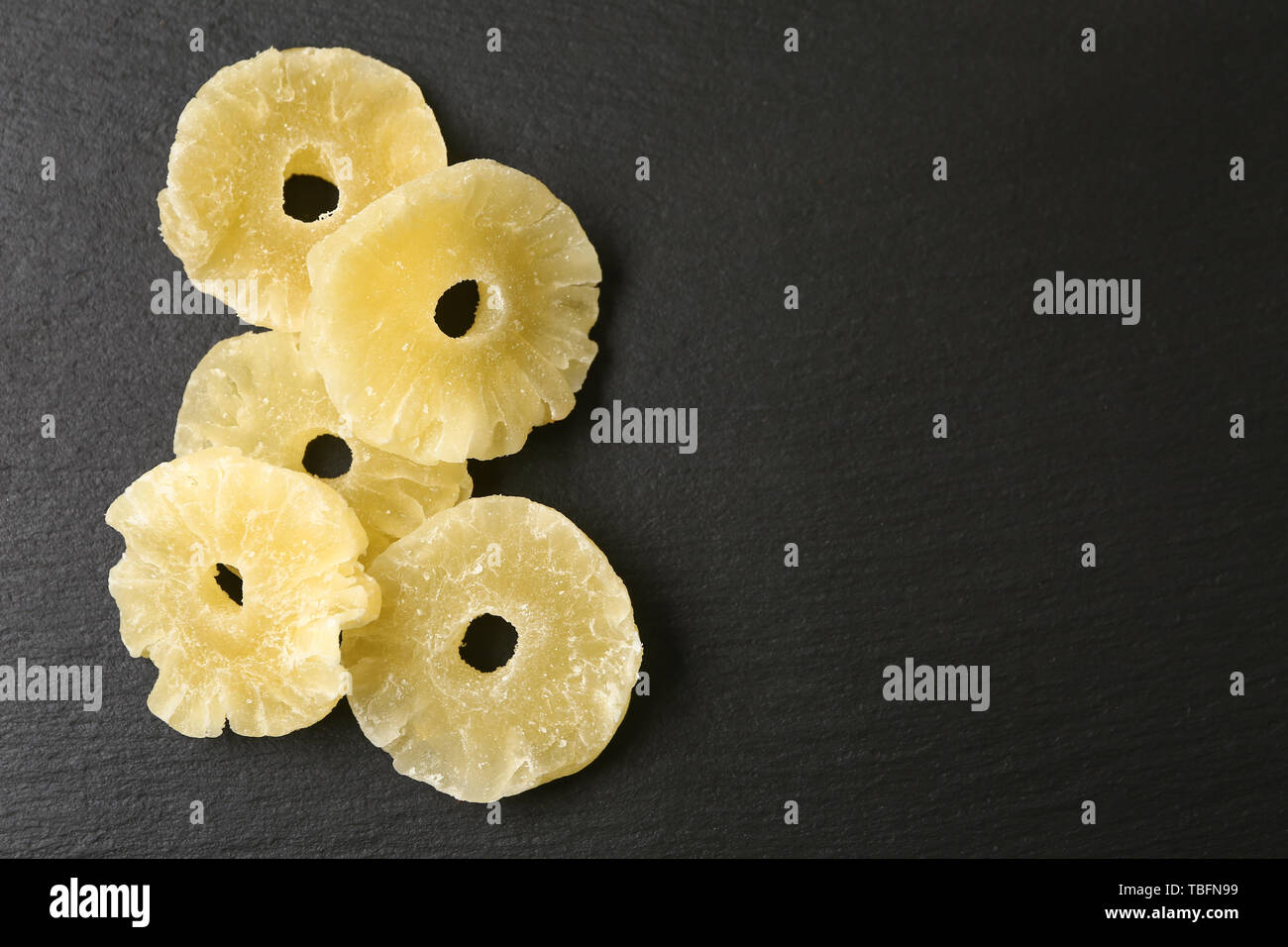 Tasty dried pineapple on dark background Stock Photo