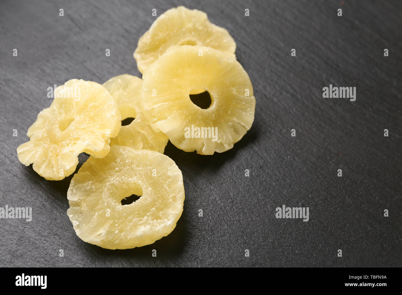 Tasty dried pineapple on dark background Stock Photo