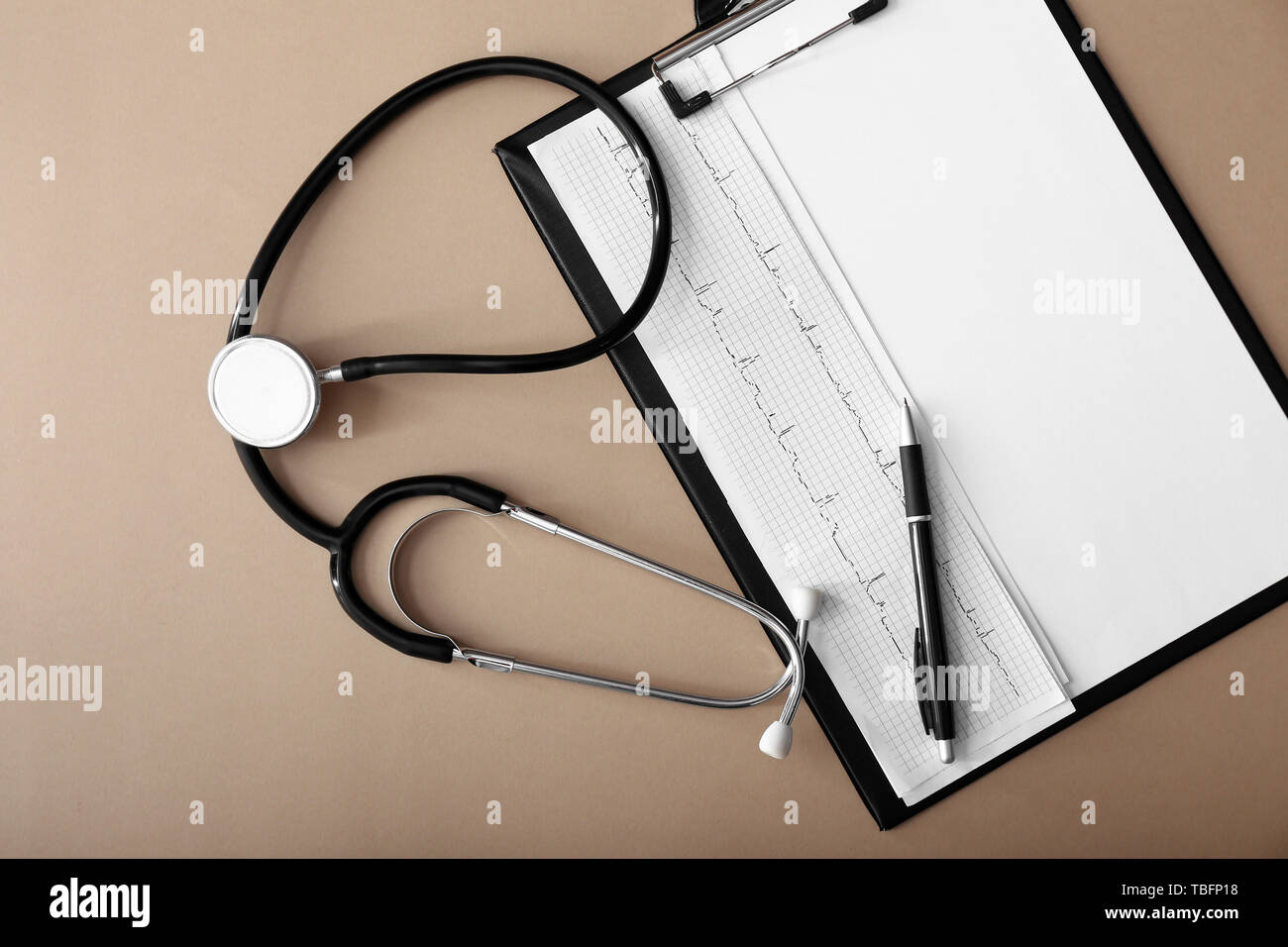 Stethoscope with cardiogram and clipboard on color background Stock ...
