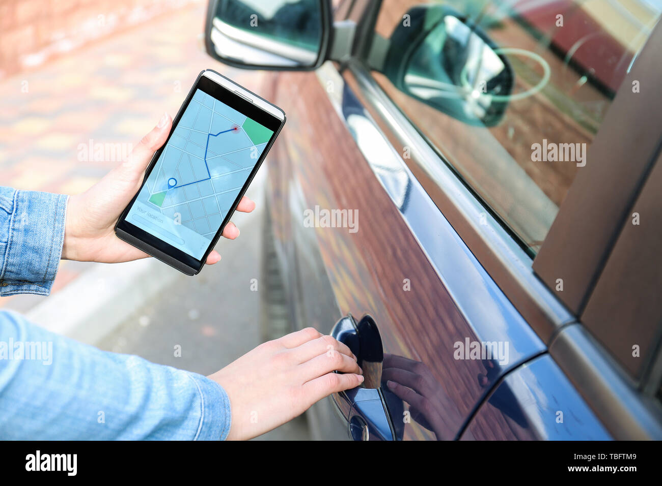 Female traveler using mobile phone for navigation outdoors Stock Photo ...