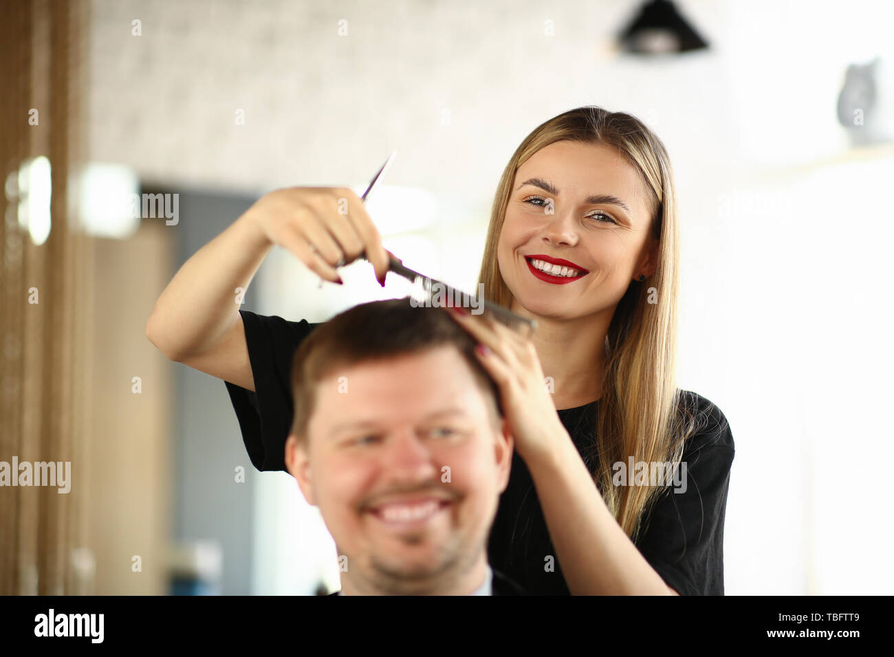 Smiling Hairdresser Combing Hair Of Male Client Woman Hairstylist