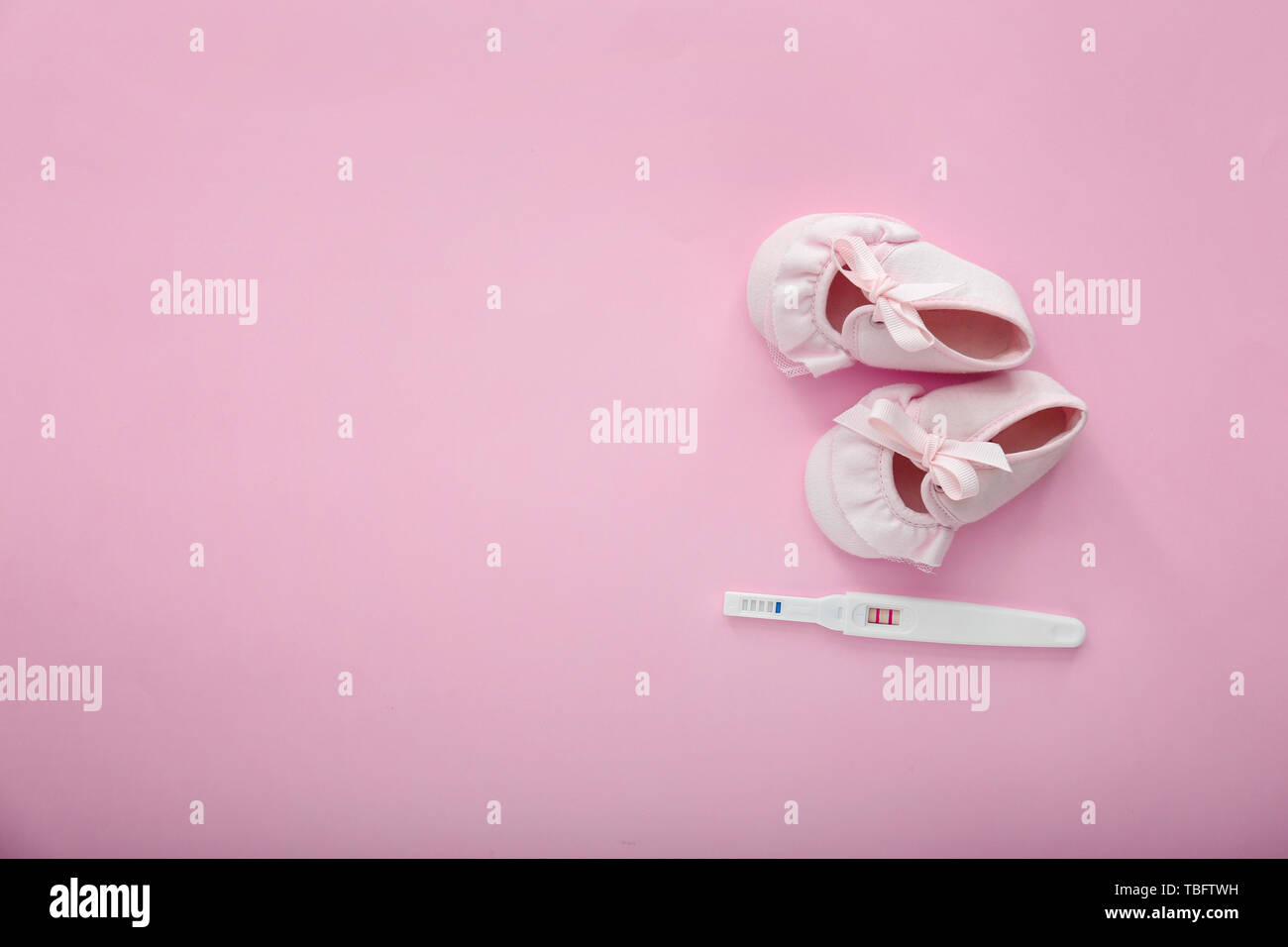 Pregnancy test and baby booties on color background Stock Photo ... Pregnancy test and baby booties on color background Stock Photo ...