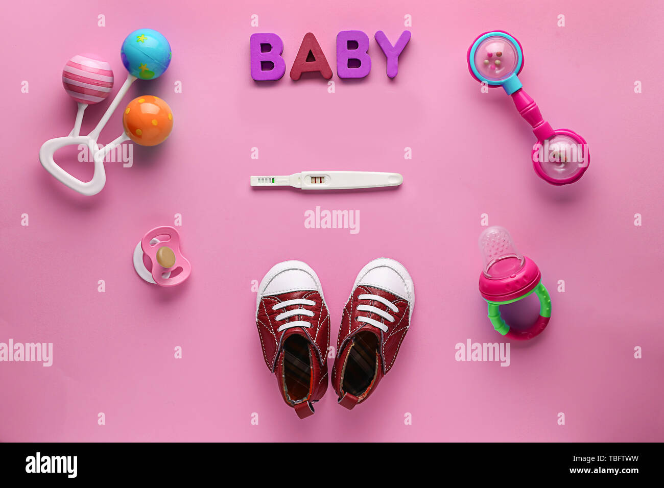 Pregnancy test and baby items on color background Stock Photo ... Pregnancy test and baby items on color background Stock Photo ...