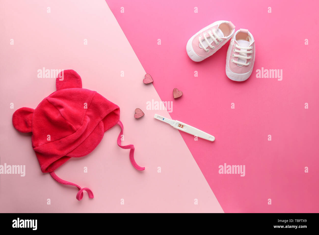 Pregnancy test, baby hat and booties on color background Stock ... Pregnancy test, baby hat and booties on color background Stock ...
