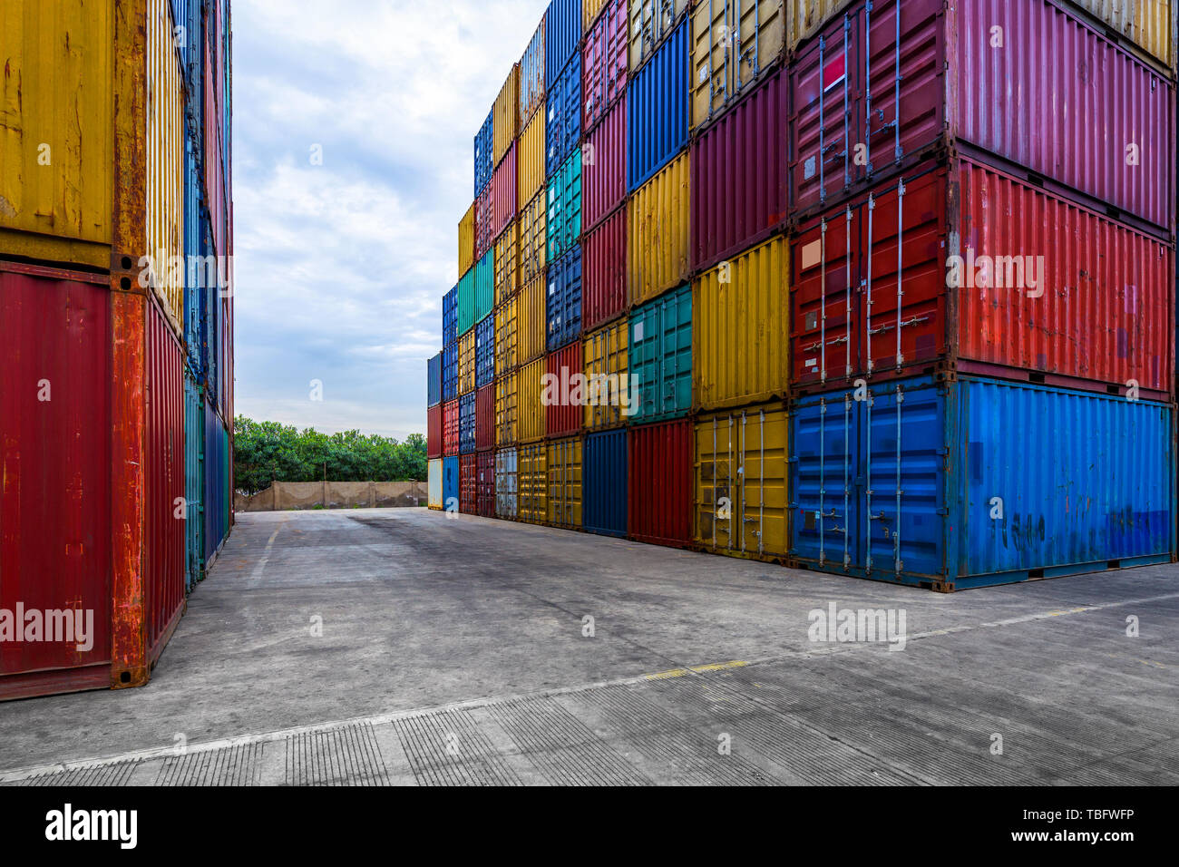 stack of containers with empty road in front Stock Photo