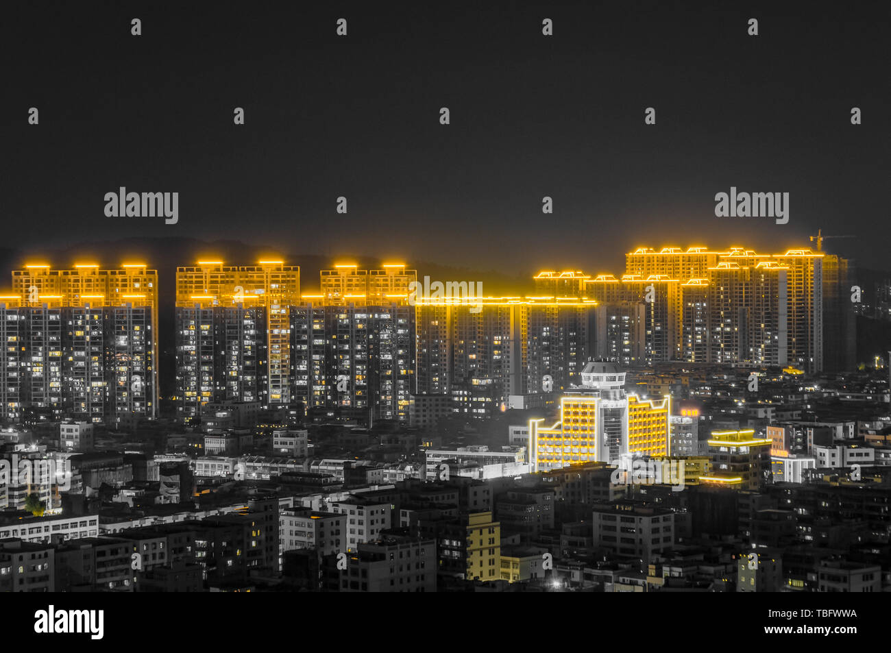 Photographed in Chaoyang District, Shantou City. Photographed using Nikon D90. Post processing into black and gold shades. The low @ - @ rise buildings in the foreground contrasted with the high @ - @ rise buildings of the vision, reflecting the speed of urbanization! Stock Photo