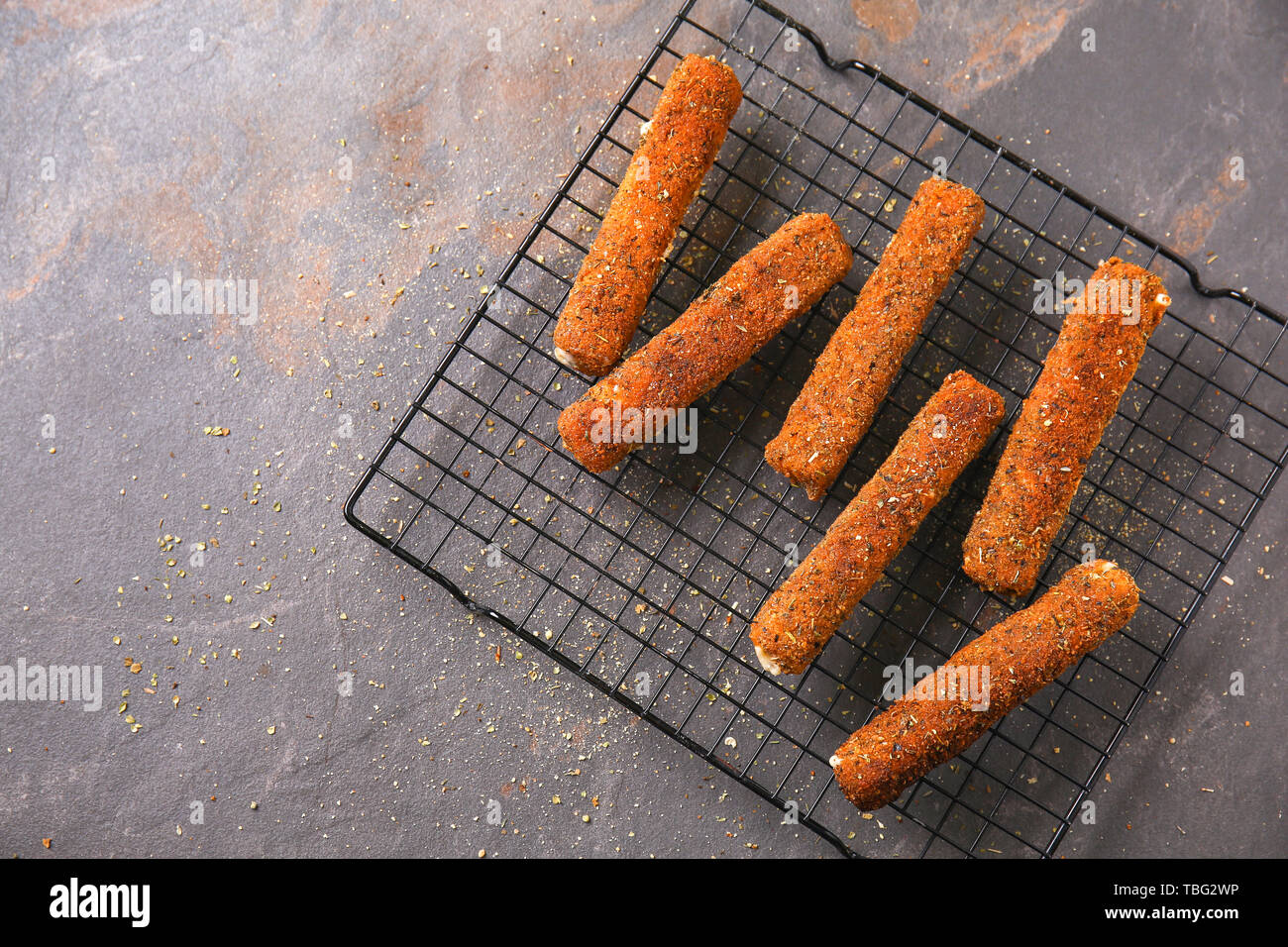 Rack with tasty mozzarella sticks on grey table Stock Photo - Alamy