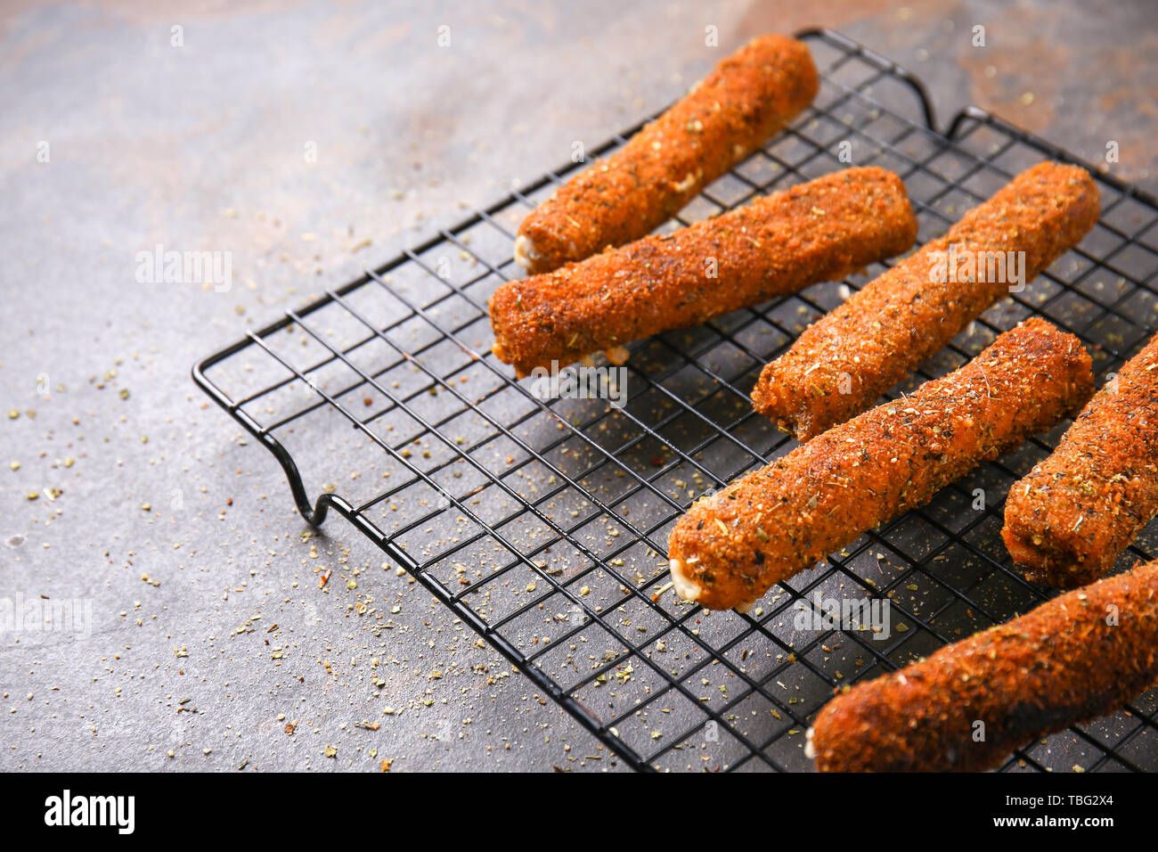 Rack with tasty mozzarella sticks on grey table Stock Photo - Alamy