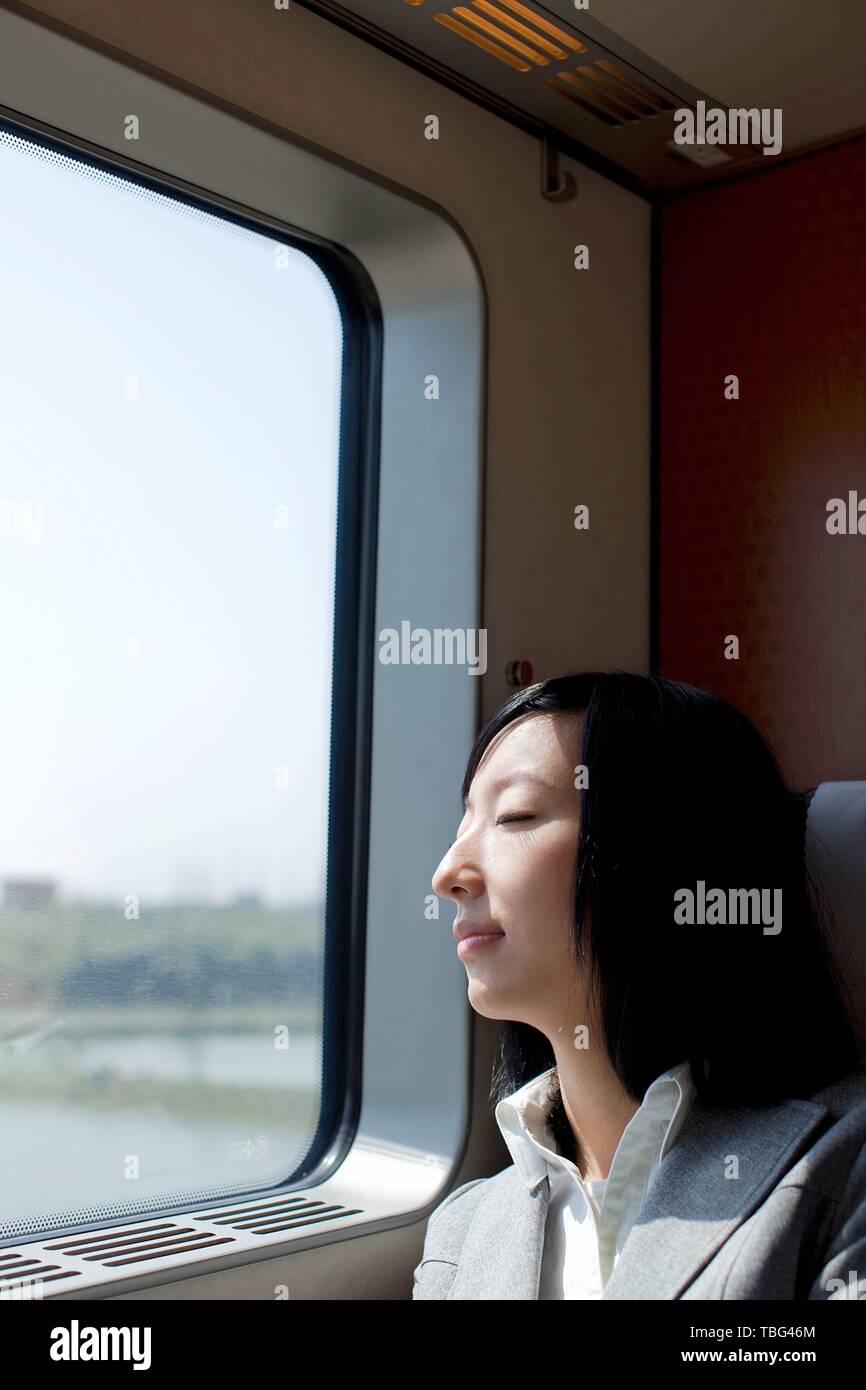 Woman sleeping on train hi-res stock photography and images - Alamy
