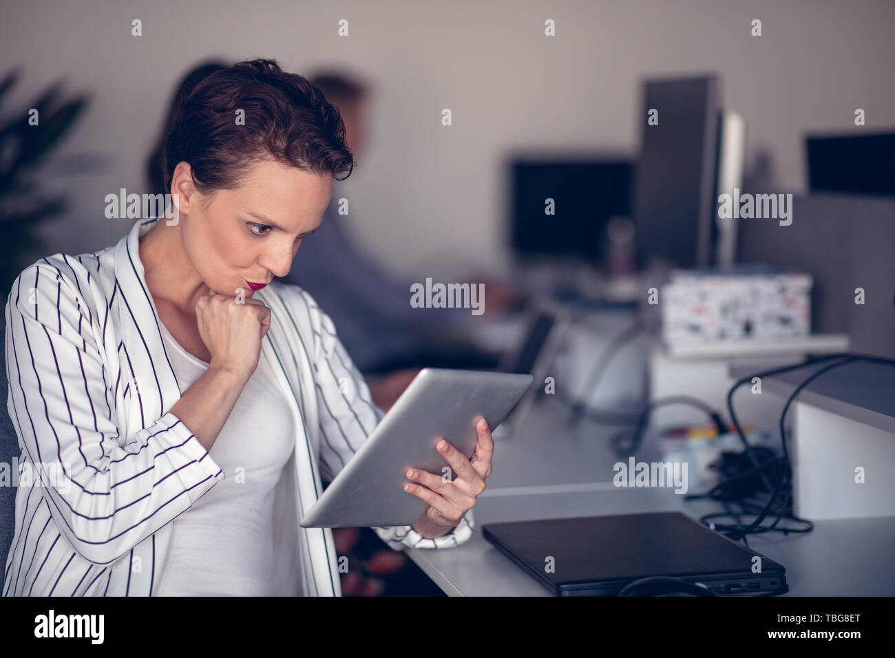 Stylish brunette working from home in her home office Stock Photo