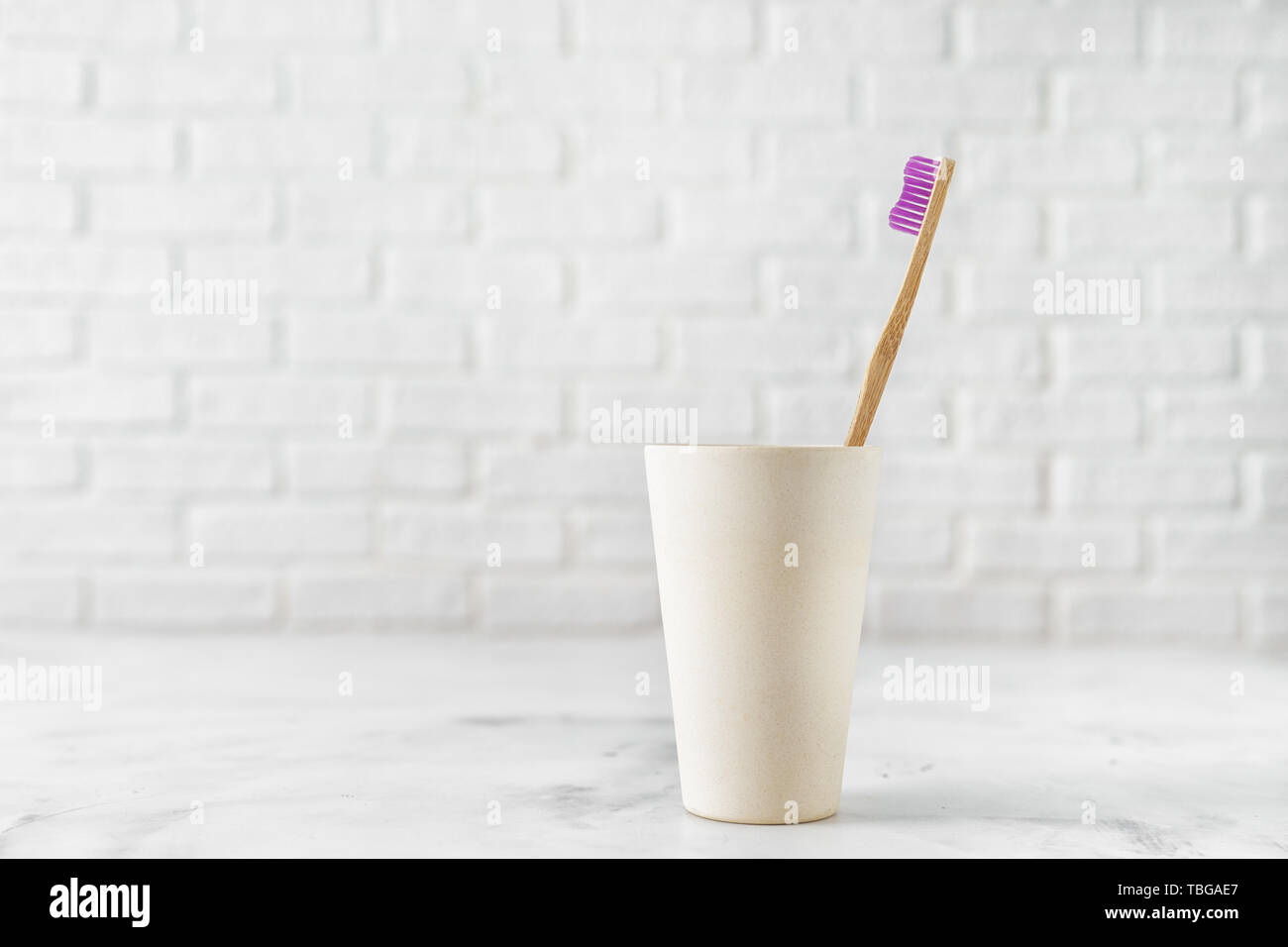 Bamboo toothbrush in holder on white background Stock Photo - Alamy