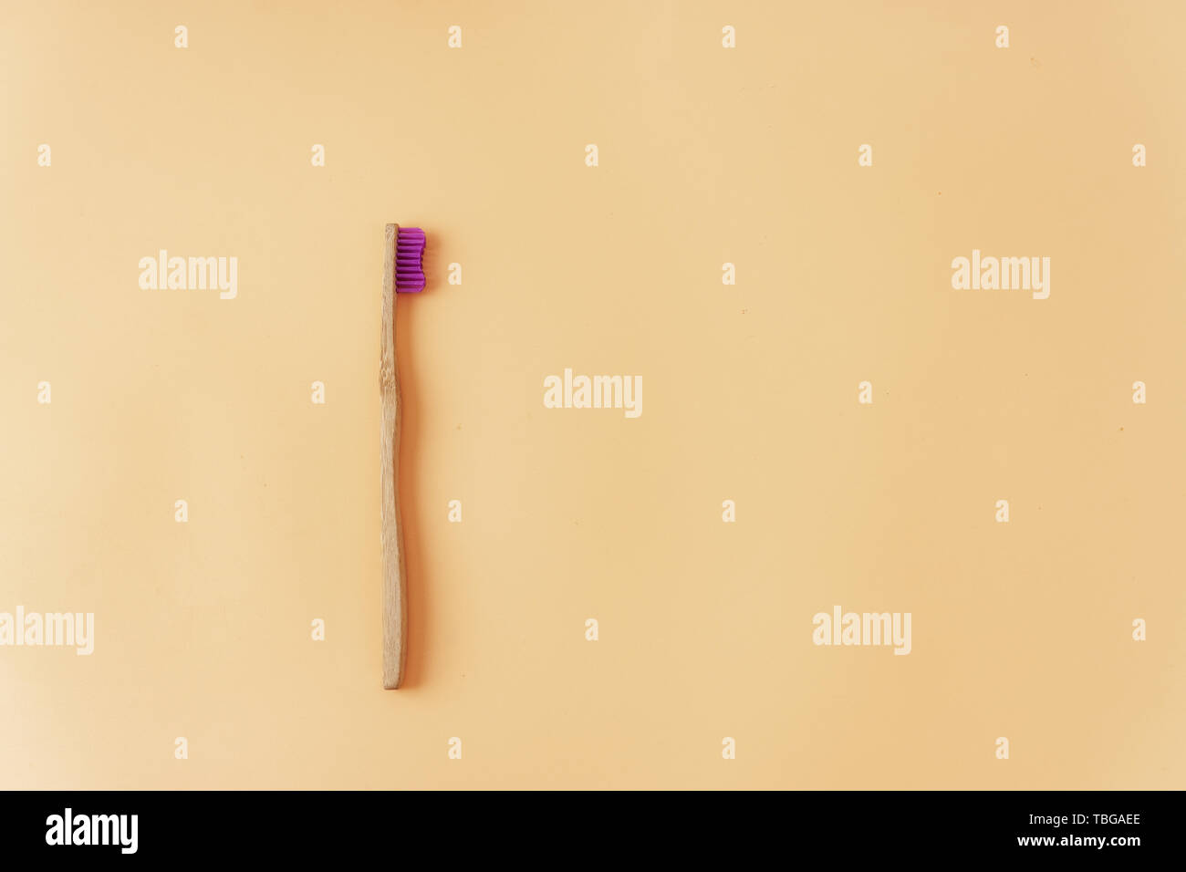 Top view of bamboo toothbrush on pale yellow background Stock Photo - Alamy