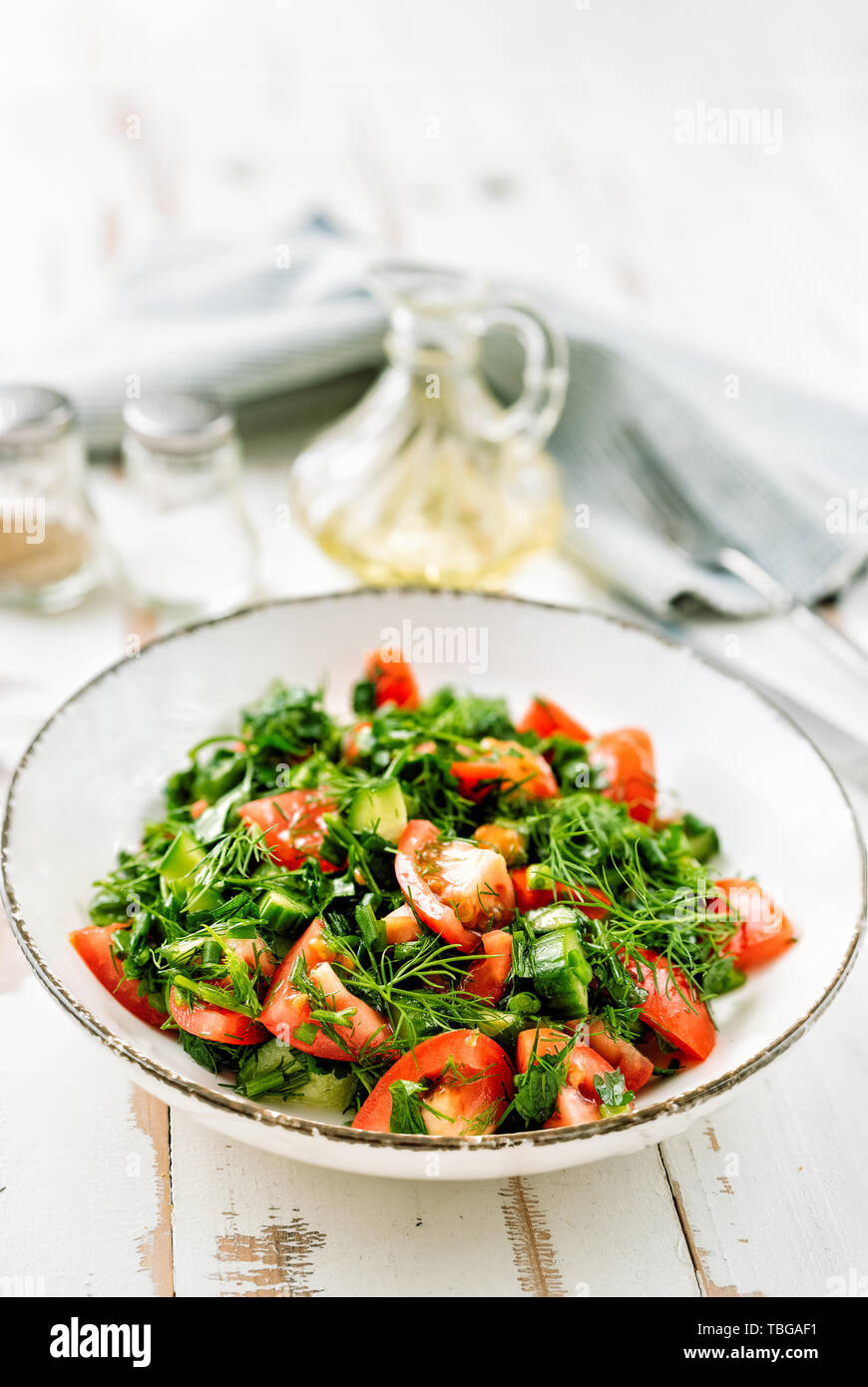 Healthy tomato salad with cucmbers, dill, onion and parsley Stock Photo