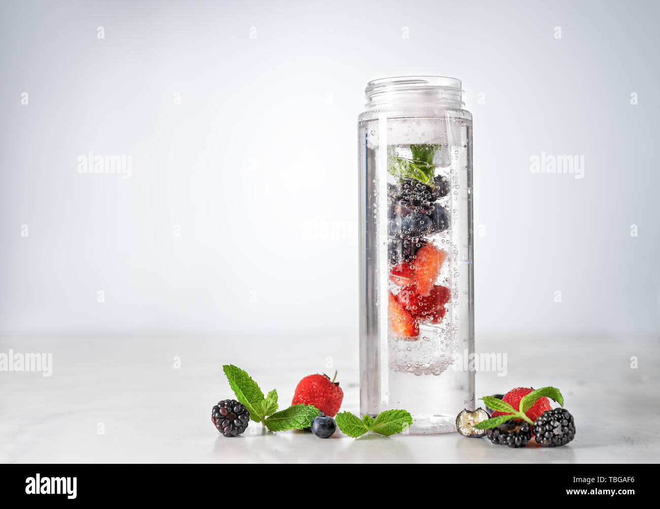 Infused water in plastic bottle with berries Stock Photo