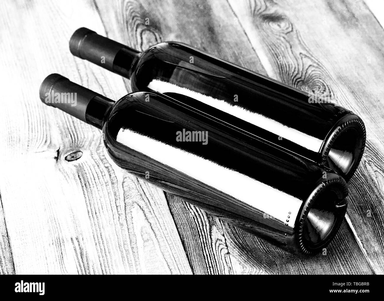 Glass bottles of wine on wooden table Stock Photo