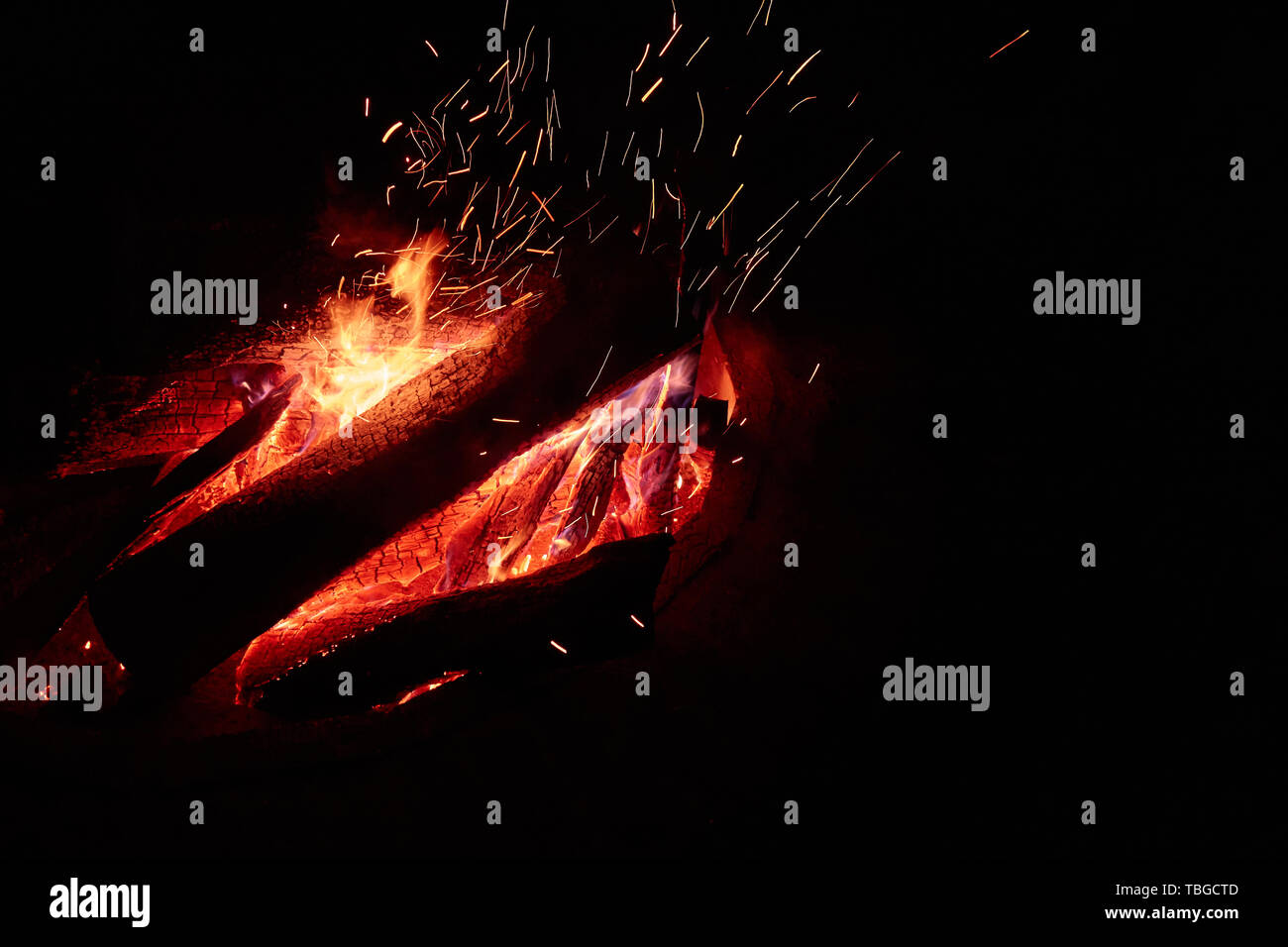 Big campfire at night with a lot of sparks isolated on the black ...