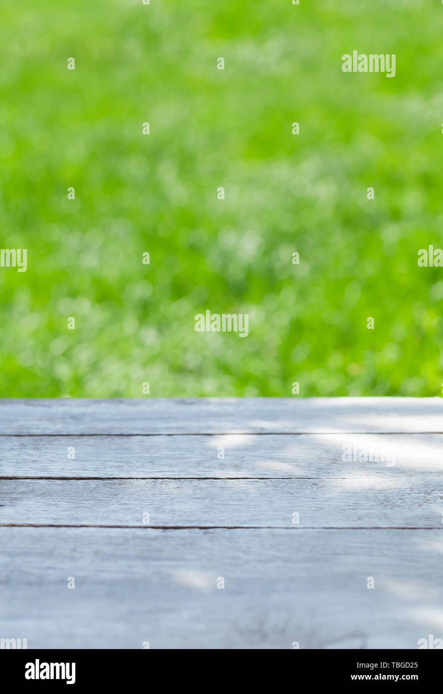 Empty wooden table over blurred sunny bokeh natural background with ...