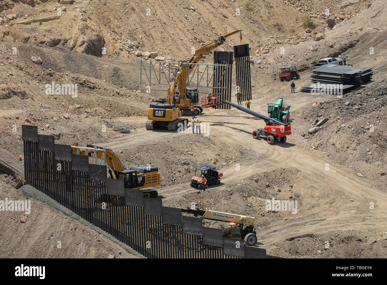 Workers assemble a section of border fence near El Paso, Texas, part of