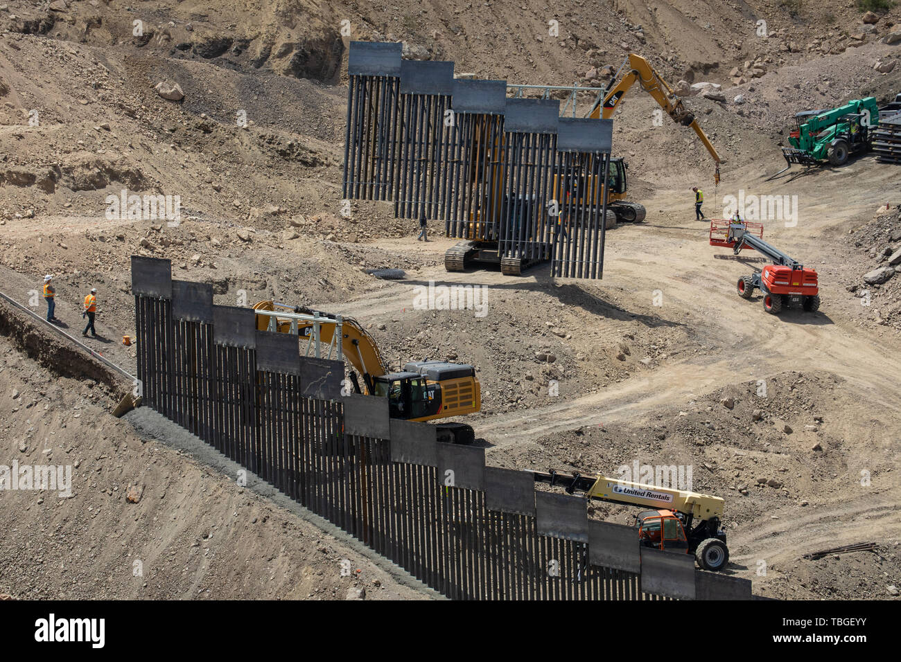 Workers assemble a section of border fence near El Paso, Texas, part of the privately-funded scheme by We Build The Wall, Inc. 30 May 2019 Stock Photo